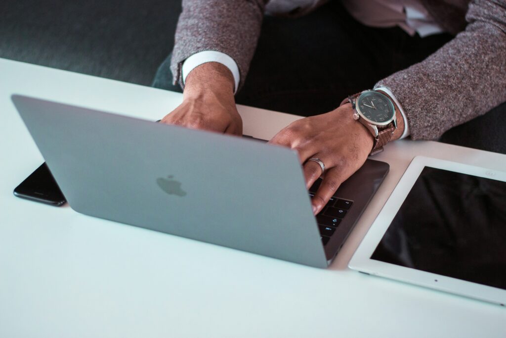 jonathan-francisca-_DtURHieodI-unsplash Man with stylish watch on working on his website's on-page SEO on his laptop.