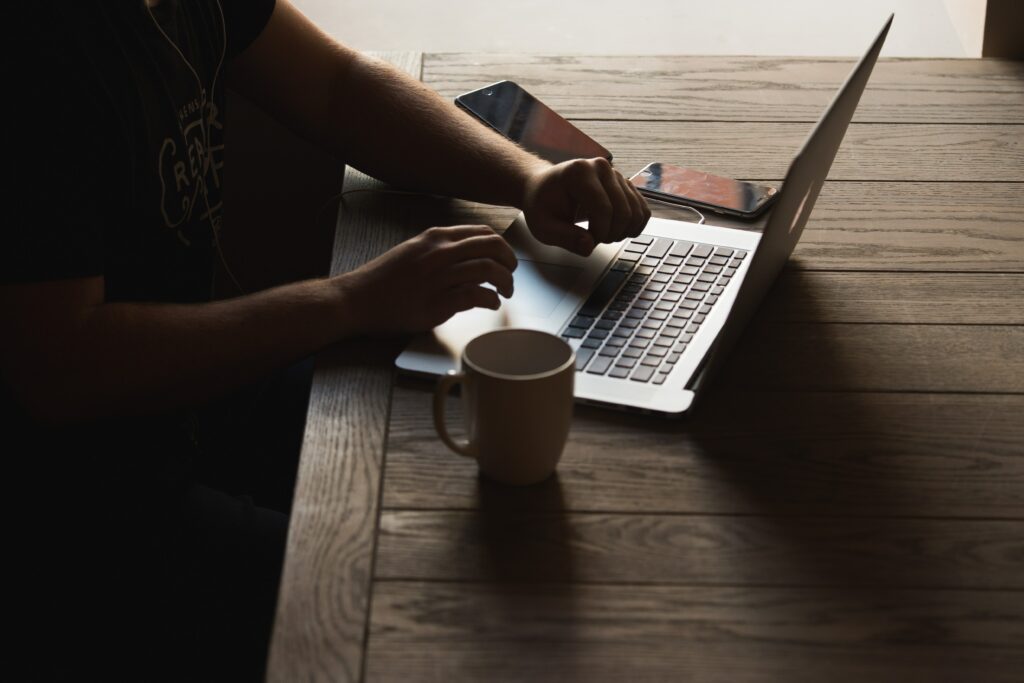 parker-byrd-gxD8hCmi0IQ-unsplash Man on his laptop going through his website's blog posts.